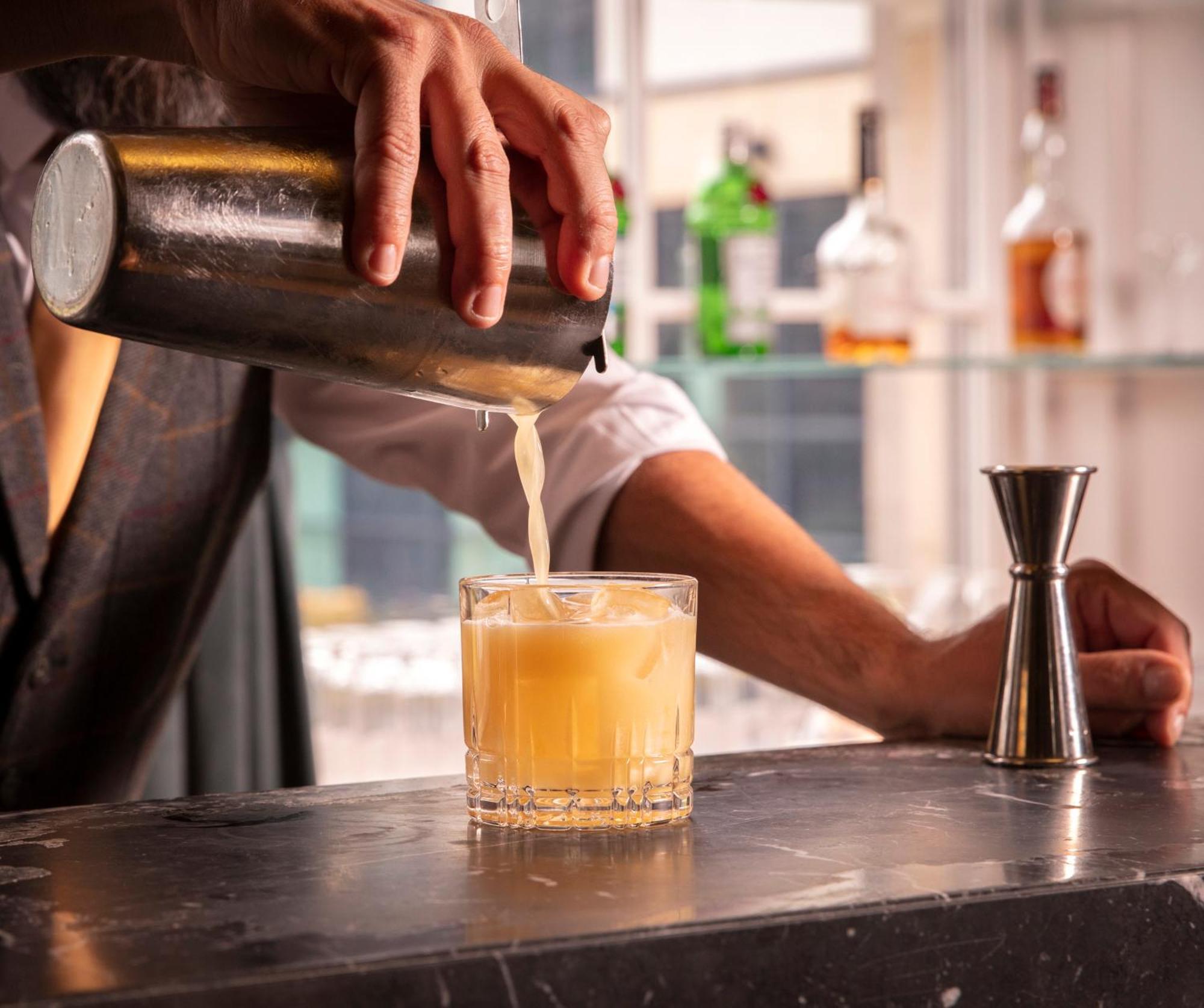 Schloss Roxburghe, Part Of Destination By Hyatt Extérieur photo A bartender straining a cocktail